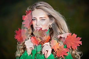 Autumn romance woman with leaves. Female model on foliage day. Dream and lifestyle. Beauty outdoor portrait. Carefree