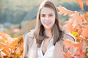 Autumn romance woman with leaves. Female model on foliage day. Dream and lifestyle. Beauty outdoor portrait. Carefree