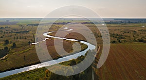 Autumn rural aerial view with agriculture fields, meadows, river