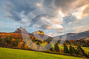 Autumn rural landscape with mountains peaks on background