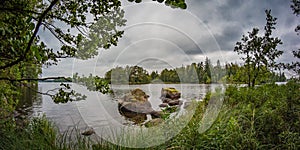 Autumn rural river shore landscape. Rural river panorama. Nature river landscape. Dramatic sky over rural river