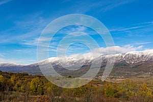 Autumn\'s Majesty: Gilded Trees and Snow-Capped Peaks