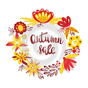 Autumn Sale. The trend calligraphy text in wreath from autumn leaves and flowers. Beautiful round wreath of autumn leaves.