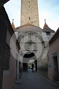 Cobblestone street and Burgtor or castle gate photo