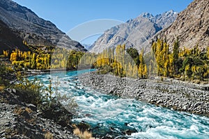 Autumn scene, blue turqu oise water of Gilgit river flowing through Gupis,Pakistan. photo