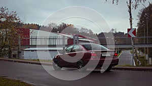 Autumn scene with Cherry red 4 door family d-class sedan Toyota Camry