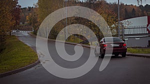 Autumn scene with Cherry red 4 door family d-class sedan Toyota Camry