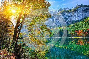 autumn scenery with Dachstein mountain summit reflecting in crystal clear Gosausee mountain lake