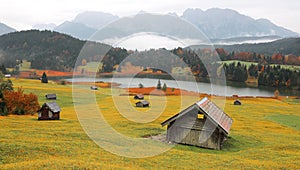 Autumn scenery of Lake Geroldsee on a foggy morning with Karwendel mountains in the background