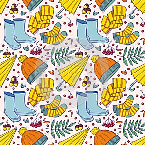 Autumn seamless pattern with cozy elements in doodle style. Vector illustration of warm clothes