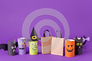 Autumn season Halloween holiday sale concept - toy from toilet roll tube? recycle idea and paper craft shopping bag on purple back