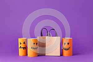 Autumn season Halloween holiday sale concept - toy from toilet roll tube? recycle idea and paper craft shopping bag on purple back