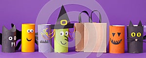 Autumn season Halloween holiday sale concept - toy from toilet roll tube? recycle idea and paper cragt shoppin bag on purple