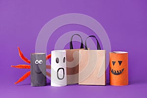 Autumn season Halloween holiday sale concept - toy from toilet roll tube? recycle idea and paper cragt shoppin bag on purple