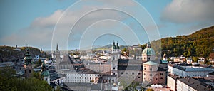 Autumn season at a historic city of Salzburg with Salzach river in beautiful golden evening light sky and