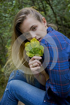 Autumn season. portrait of a woman playing with leaves