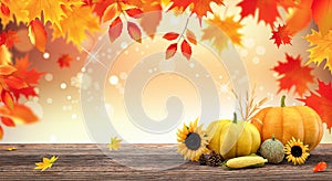 Autumn seasonal background with red falling leaves and fall decorations on wooden plank