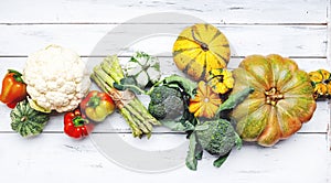 Autumn seasonal food, vegetarian cooking ingredients. Organic vegetables, pumpkin, asparagus, paprika, cauliflower and broccoli on