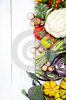 Autumn seasonal food, vegetarian cooking ingredients. Organic vegetables, pumpkin, mushrooms, asparagus, paprika, legumes,