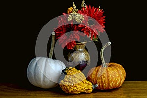 autumn setting pumkins gourds and flowers