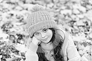 Autumn skin care routine. Kid wear warm knitted hat. Warm woolen accessory. Girl long hair happy face autumn nature
