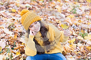 Autumn skin care routine. Kid wear warm knitted hat. Warm woolen accessory. Girl relaxing autumn nature background