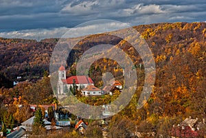 Autumn at Sklene Teplice with church at Stiavnicke vrchy mountains