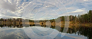 Autumn sky with light clouds over a body of water