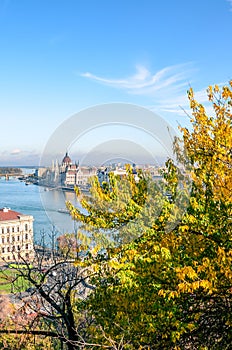 Autumn skyline of Budapest, Hungary with fall trees in the foreground. Hungarian Parliament Building, Orszaghaz, in the background photo