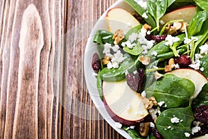 Autumn spinach salad with apple cheese , walnut and dried cranberry . Healthy vegetarian food