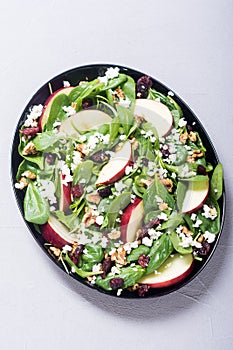 Autumn spinach salad with apple cheese , walnut and dried cranberry . Healthy vegetarian food