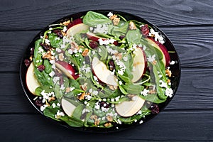 Autumn spinach salad with apple cheese , walnut and dried cranberry . Healthy vegetarian food