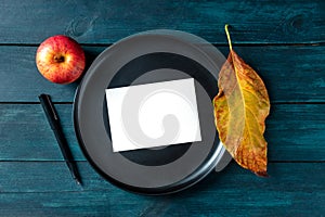 Autumn stationery mockup, a blank greeting card or invitation, shot from above on a tray with a place for text