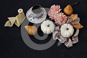 Autumn still life composition. Cup of coffee, pear fruit and white pumpkins with pink dahlia flowers on black table