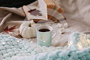 Autumn still life. A cup, dried leaves, book and pumpkin. Hygge lifestyle, cozy autumn mood. Flat lay, thanksgiving background