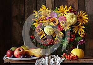 Autumn still life with flowers and fruit.