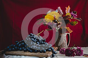 Autumn still life grapes and autumn flowers