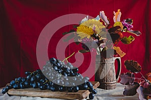 Autumn still life grapes and autumn flowers