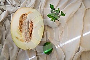 Autumn still life of half ripe melon with seeds in the middle and yellow peel