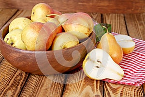 Autumn still life. Pears on old wooden table with red checkered tablecloth. Rustic design