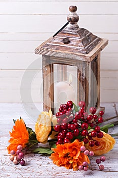 Autumn still life photo with flowers in yellow colors and candl