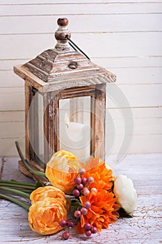 Autumn still life photo with flowers in yellow colors and candl