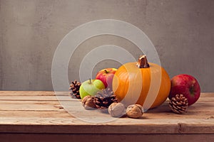 Autumn still life with pumpkin, apples and pine corn on wooden deck