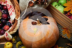 Autumn still life in rustic style as a background - leaves, vegetables and fruits, nuts and other natural food ingredients on