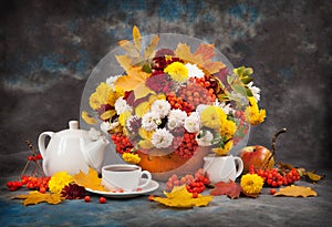 Autumn still life. Tea, flower and yellow leaves