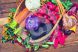 Autumn still life with vegetables, dry leaves and berries.