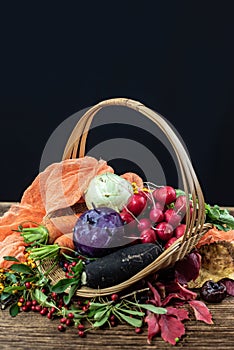 Autumn still life with vegetables, dry leaves and berries.