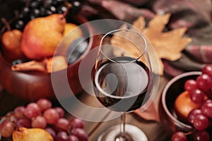 Autumn still life with wine, grapes and dry leaves
