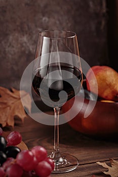 Autumn still life with wine, grapes and dry leaves