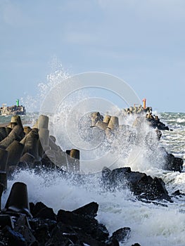 An autumn storm rages in the baltic sea, hitting the waves against a breakwater